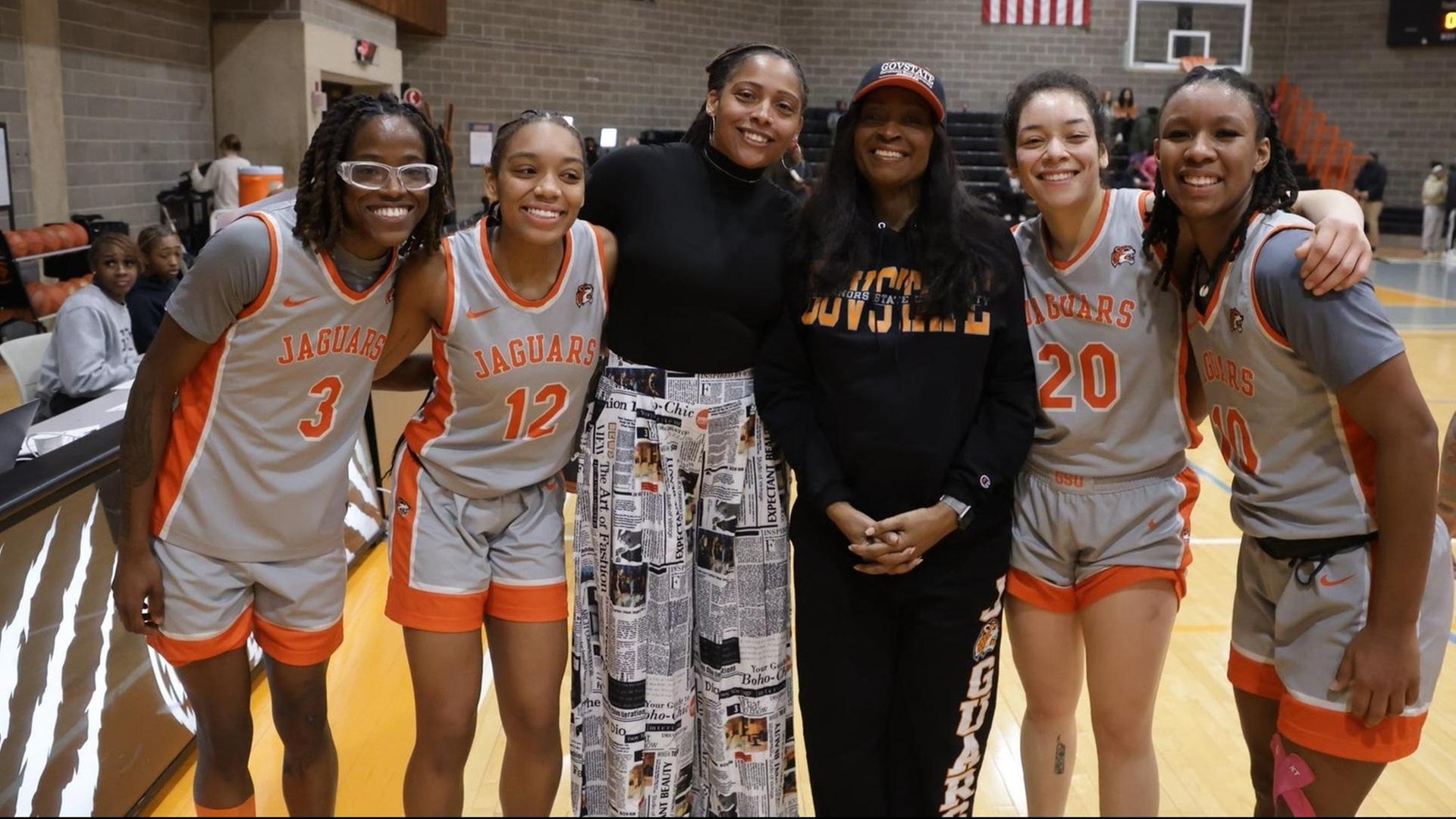 Photo by Ven Sherrod.  Governors State University President Dr. Cheryl Green pictured with GSU Head Women's Coach Tonishea Mack and some of her first place CCAC leading Jaguars 2024-25 team at the ARC Saturday.